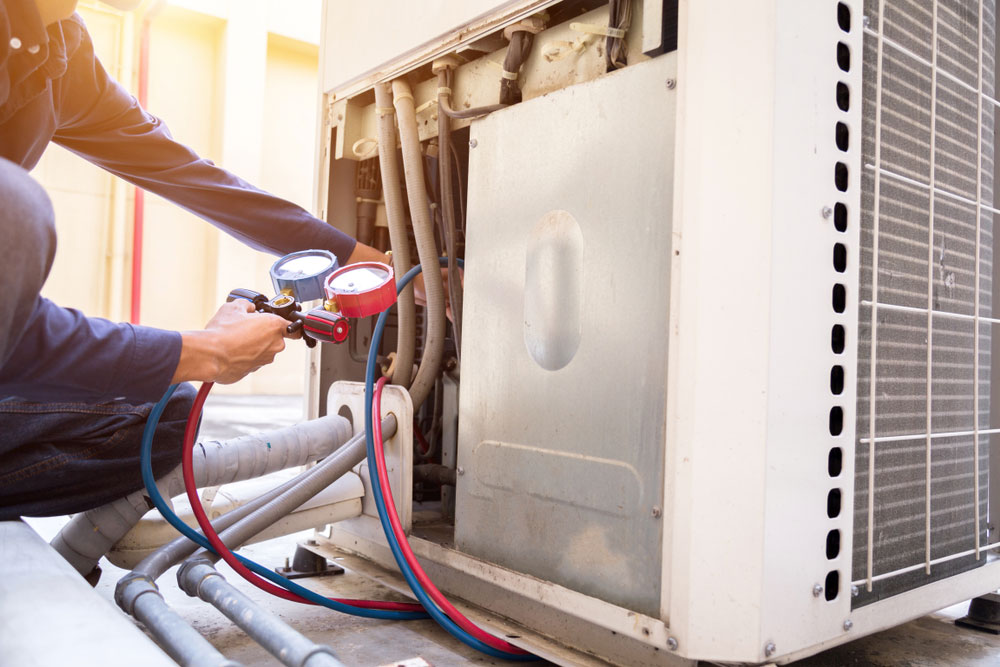 HVAC Services in Houma, LA Technician checking air conditioner