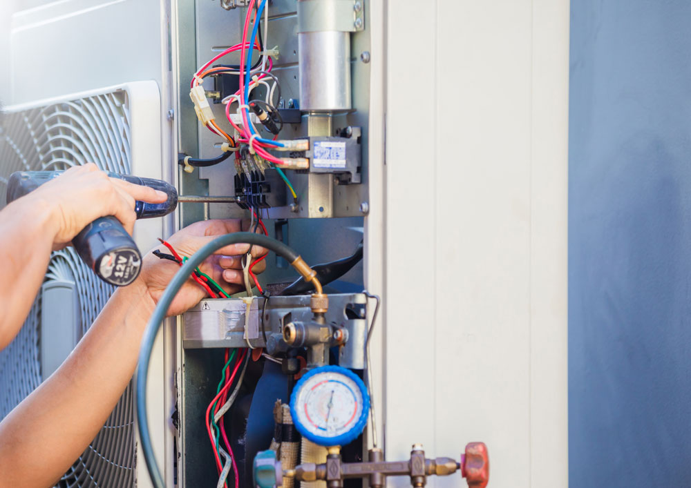 HVAC Repair Services in Houma, LA Male,technician,hands,using,a,screwdriver,fixing,modern,air,conditioner,